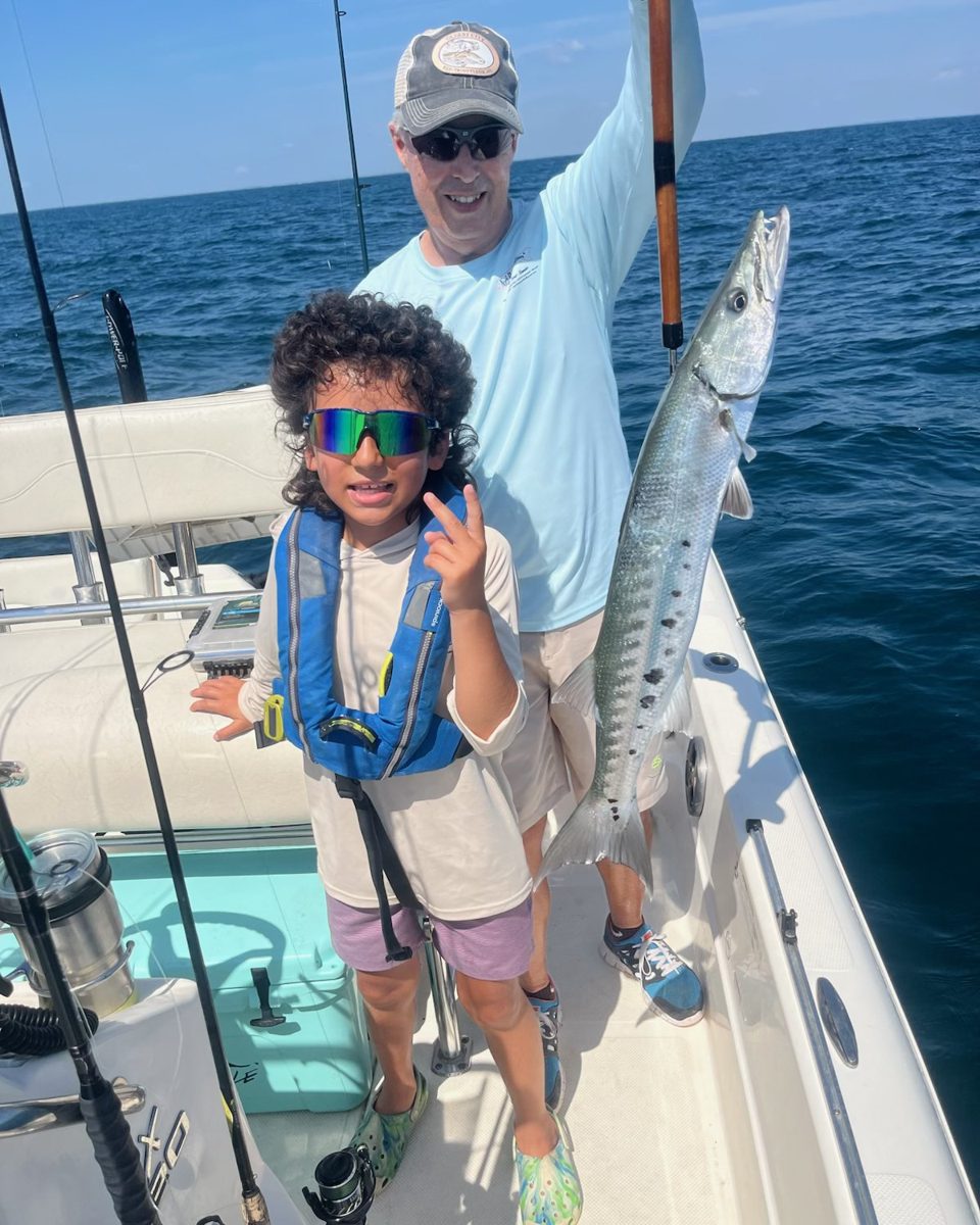 Capt. Fred Rounsaville and a camper with a barracuda